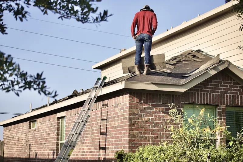 Professional roofer working on a residential roof in Kennebunk